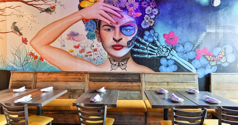 Interior, tables and chairs, colorful painting on the wall