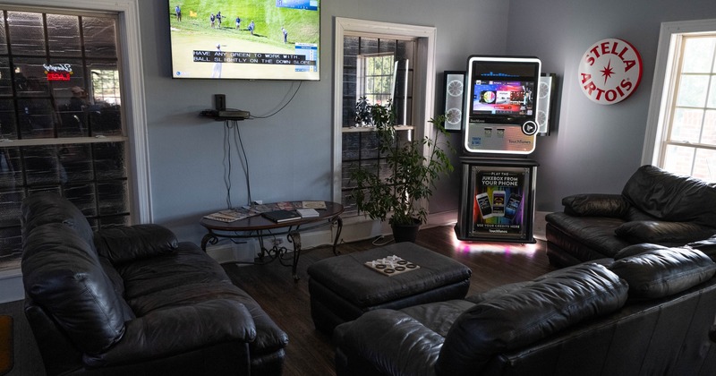 Lounge area featuring dark leather sofas