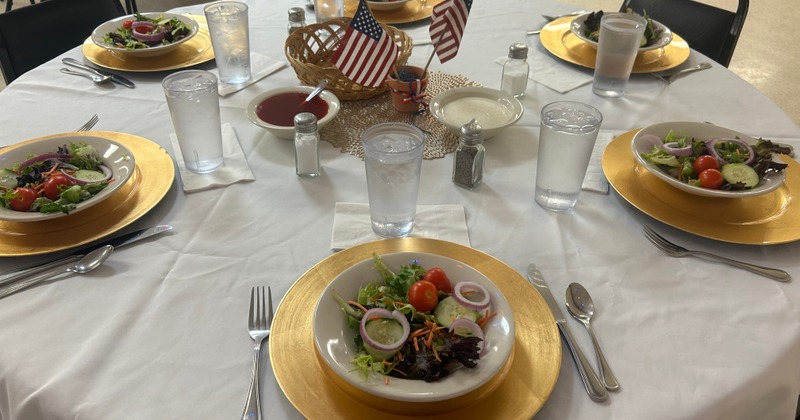 Table setting with served salad plates