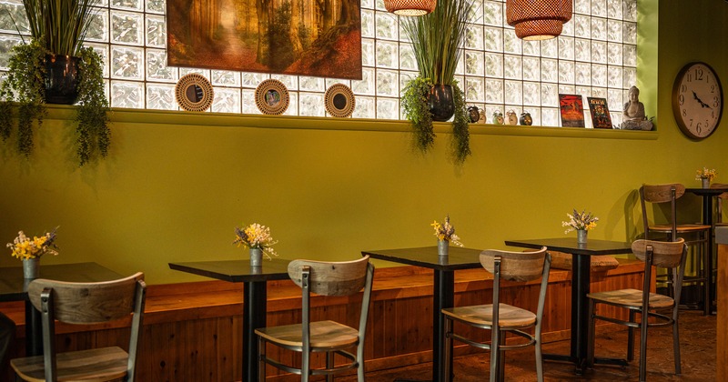 Cozy interior dining area with wooden tables lined up along the wall