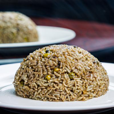 Black rice molded into dome shape for serving.