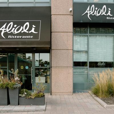 Storefront with signage, and planters.