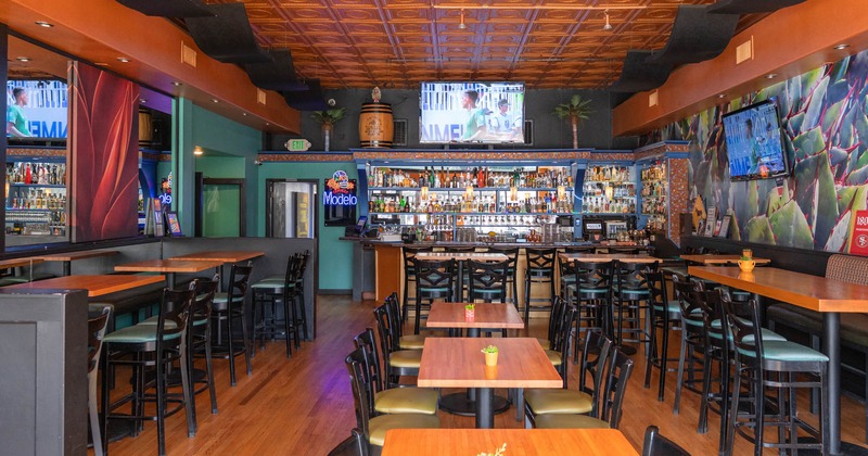 Interior, bar and seating area, regular tables for four, high seating tables with stools