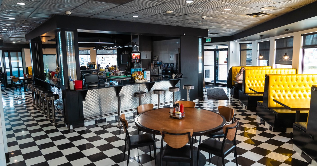 Interior, seating area with booths, tables and ordering counter