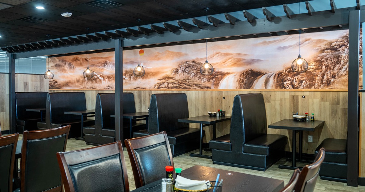 Interior, seating area, leather padded seating booths with tables, low hanging lanterns