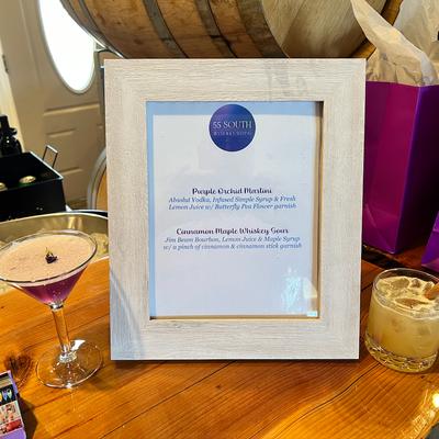 Purple Orchid Martini and Cinnamon Maple Whiskey Sour cocktails on display.