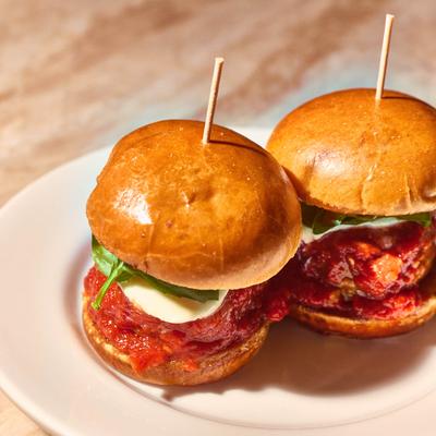 Chicken sliders with tomato sauce.