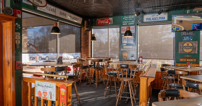 Wooden bar stools and tables by the window
