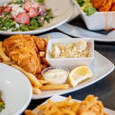 Fish and Chips, served with tartar sauce, and coleslaw.