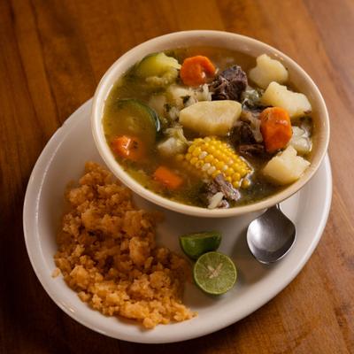 Mexican beef and vegetable soup served with seasoned rice.