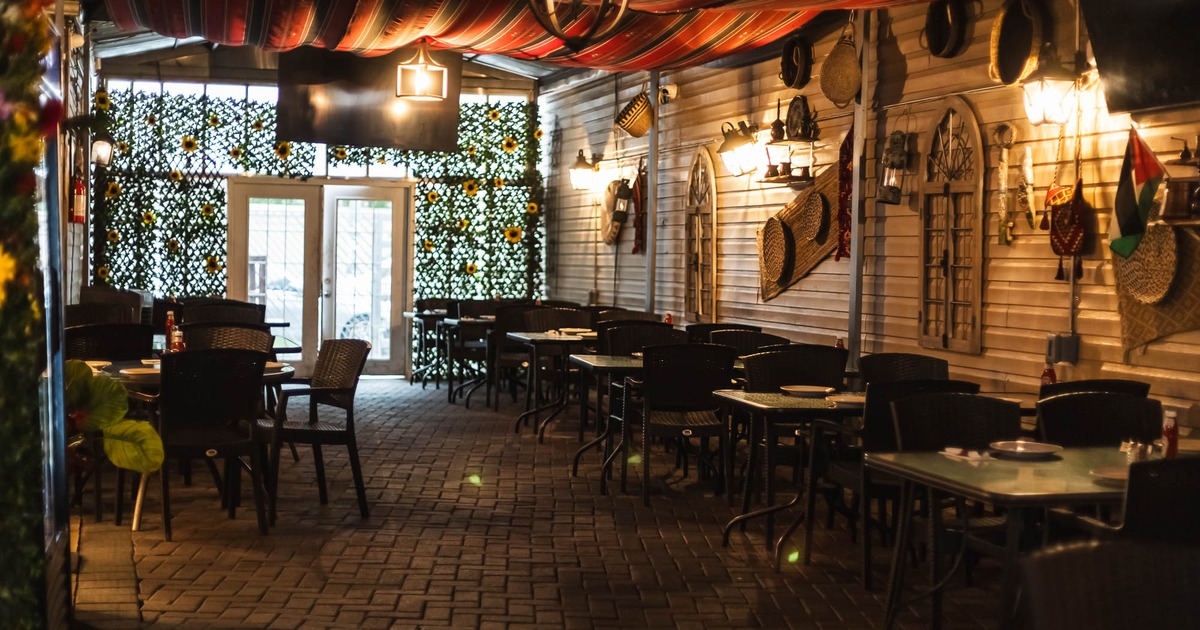 Interior, tables and chairs with entrance in the back