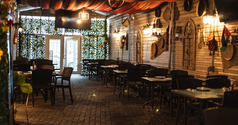 Interior, tables and chairs with entrance in the back