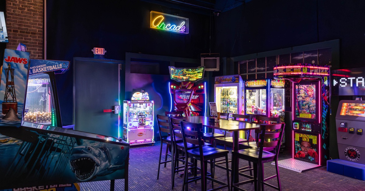 Arcade area with machines and neon arcade sign