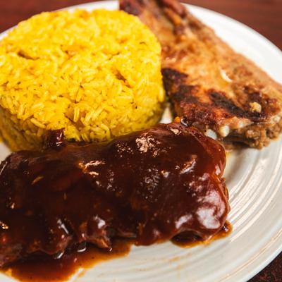 Ribs with BBQ sauce and rice.