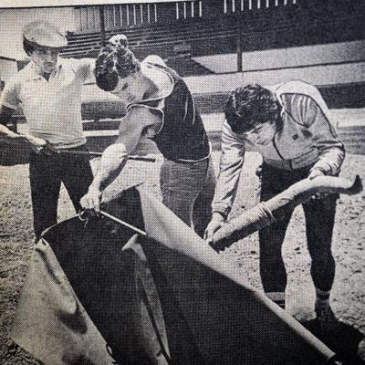 A bullfighter practicing for a corrida with two other people