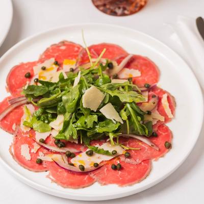 Thinly sliced filet mignon topped with arugula, capers, marinated onion, and shaved Parmesan.