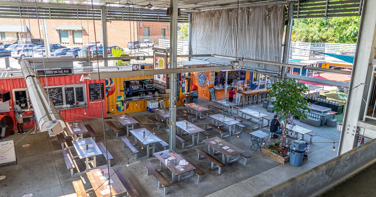 Spacious, open-air dining and gathering area with a modern industrial design