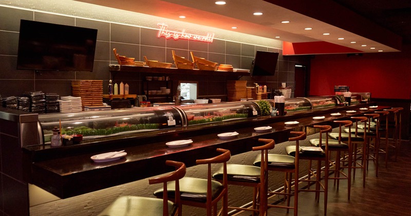 Interior, kitchen with bar and bar stools, warm lights, kitchen equipment, neon sign