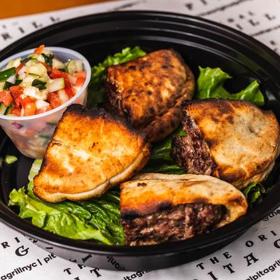 Grilled beef arayes served with chopped vegetable salad.