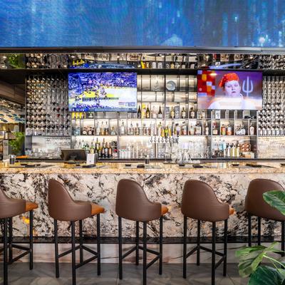 Front view of bar with bar chairs.