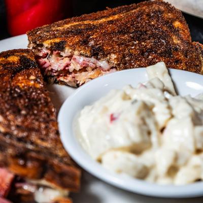 Reuben  with a side of potato salad.