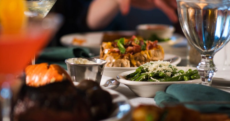 Interior, guest table with served food and drinks, closeup