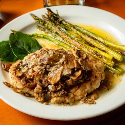 Grilled chicken, with mushrooms, garlic butter sauce, and asparagus.
