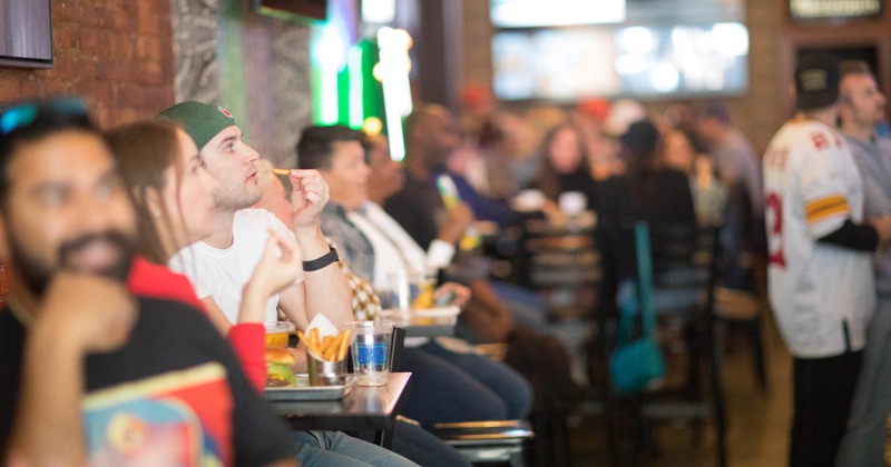 Interior, guests dining and watching sports broadcasts