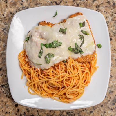 Chicken Parmesan over spaghetti.