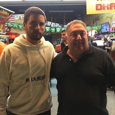 Interior, two guests posing for a photo.