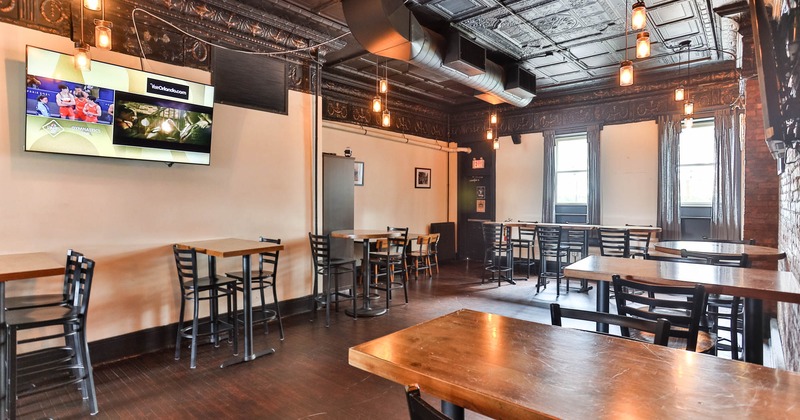 Interior, bar tables and chairs, TV on the wall