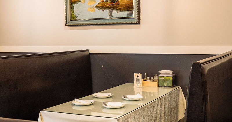 Upholstered dining booth set for four guests