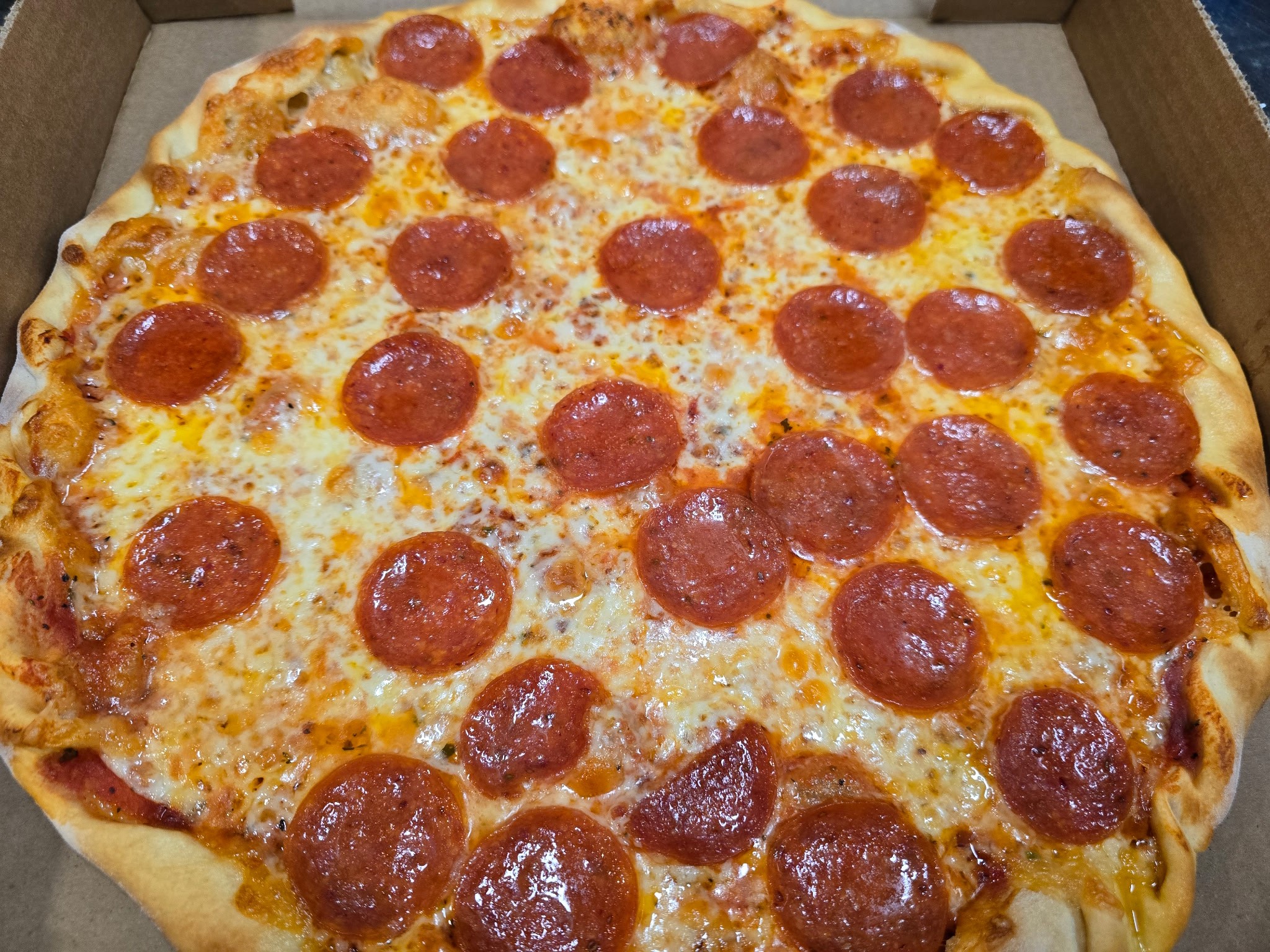 Large pepperoni pizza with melted cheese
