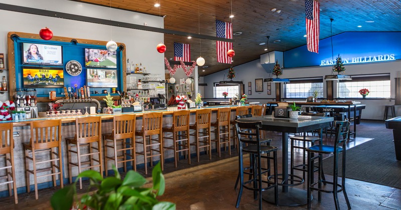 Bar area, tall table and bar stools next to the bar