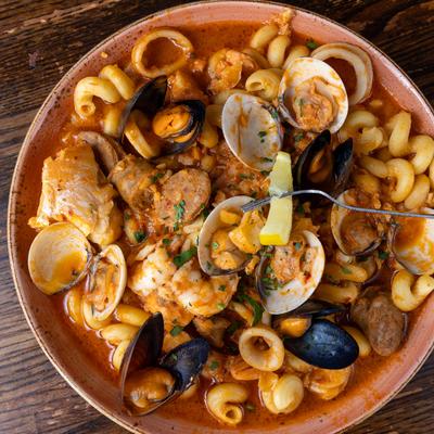 Cioppino with clams, shrimps, mussels and calamari, top view.
