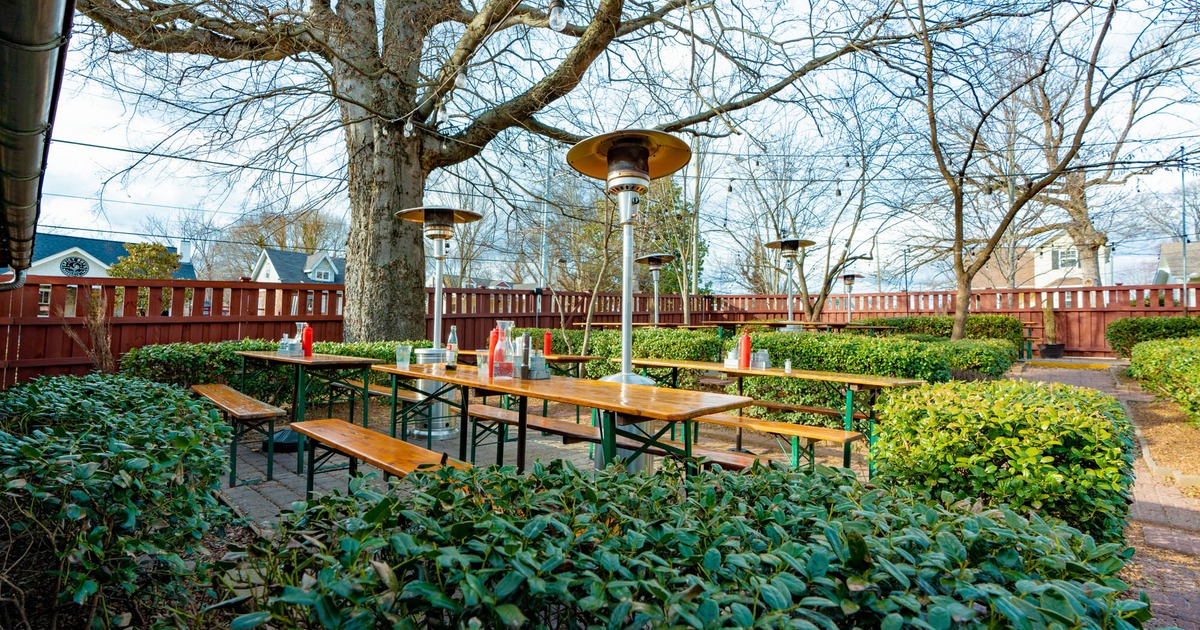 Beer garden patio, tables and benches, patio heaters and greenery