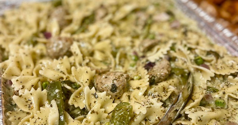 Tray of bow tie pasta with herbs and vegetables