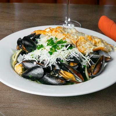 Steamed mussels with linguine pasta, topped with Parmesan cheese and sexy bread.