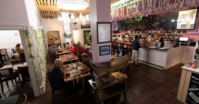 Interior, wide view, diner area, tables, chairs, screens, bar, drink rack