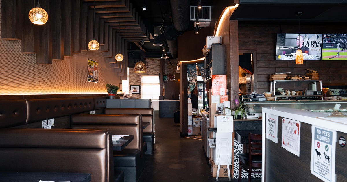 Interior dining area of a Japanese sushi restaurant, lined up dining booths
