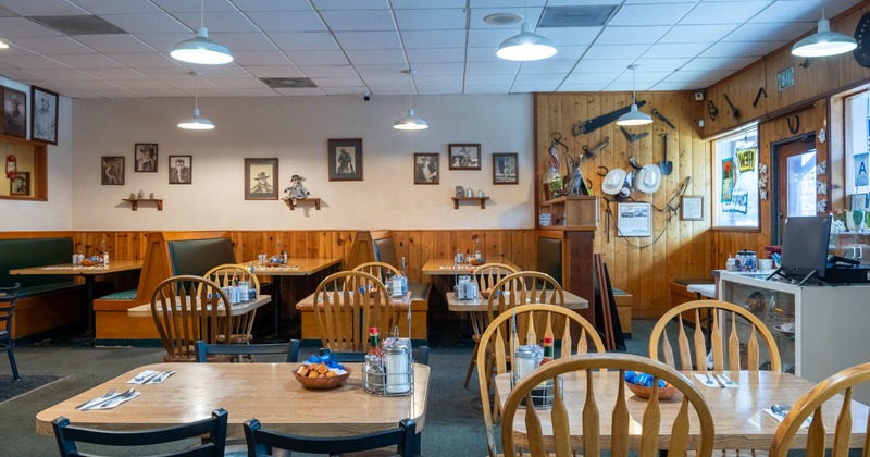 Cozy restaurant interior with wooden seating and rustic Western decor