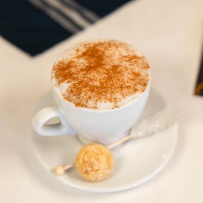 Cappuccino served with cinnamon topping.