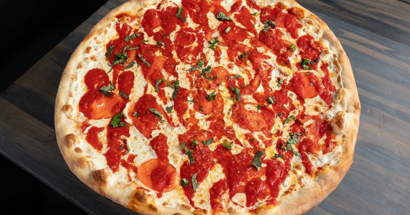 Whole Margherita pizza, served