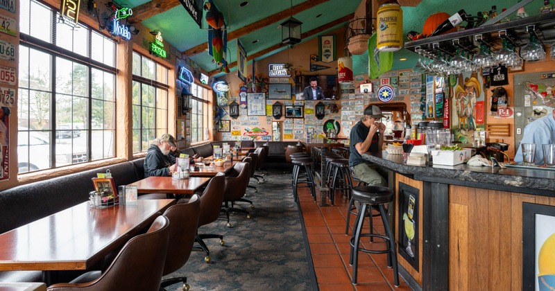Interior, tables and chairs on the left, bar and bar stools on the right