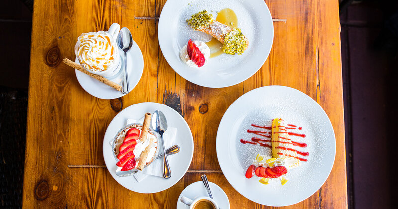 Different types of dessert on the table, coffee on the side