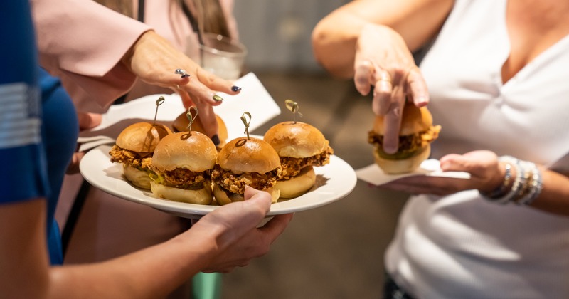 Staff member serving sliders