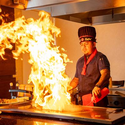 A chef performing the Teppanyaki cooking style.