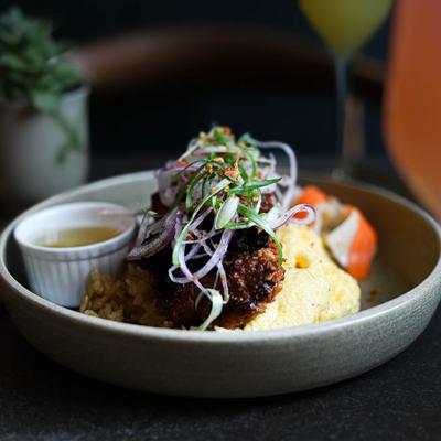 Pork sausage with garlic fried rice, scrambled eggs, and onion slaw.