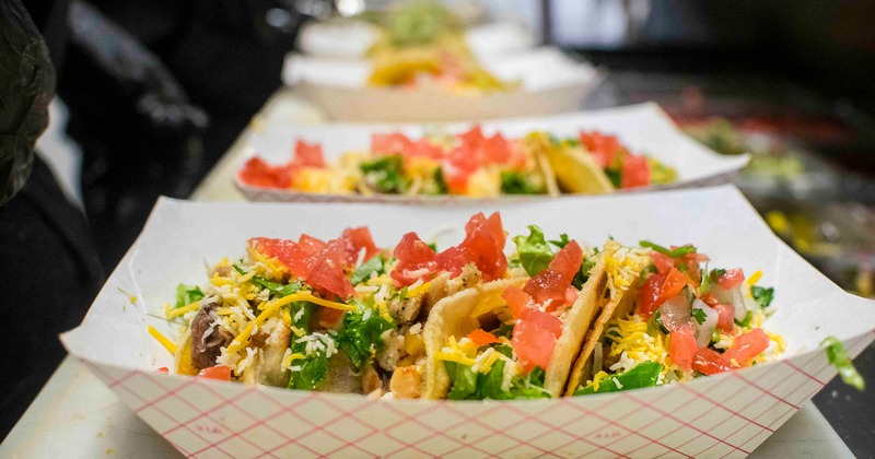 Takeout plates with tacos at taco bar