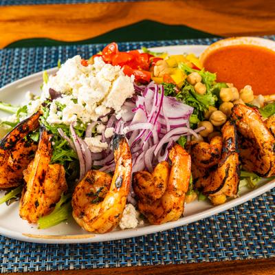 Grilled shrimp salad, with greens, tomatoes, bell peppers, chickpeas, red onion, and feta.